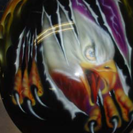 Custom motorcycle paint job with airbrushed eagles and flames