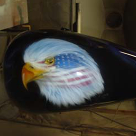 Custom motorcycle paint job with airbrushed eagles and war paint