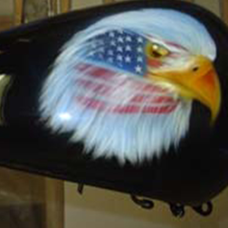 Custom motorcycle paint job with airbrushed eagles and war paint