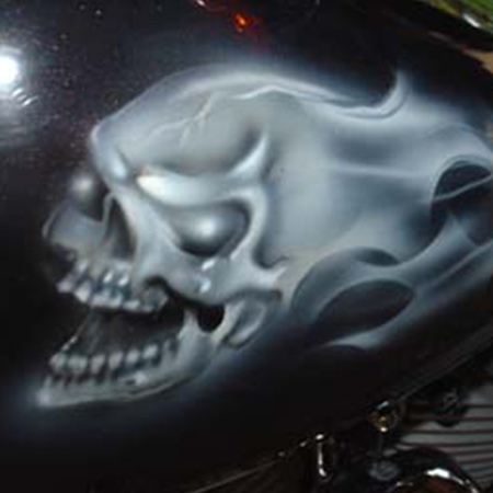 ghost skulls and flames airbrushed on a motorcycle