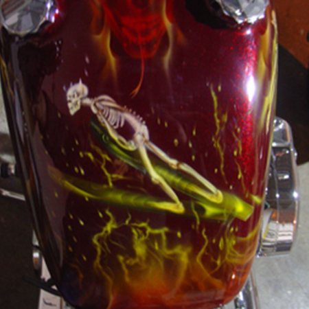 custom kandy paint job on motorcycle with airbrushed skulls and flames