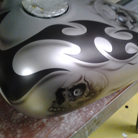 custom painted motorcycle with airbrushed skulls and tribal flames