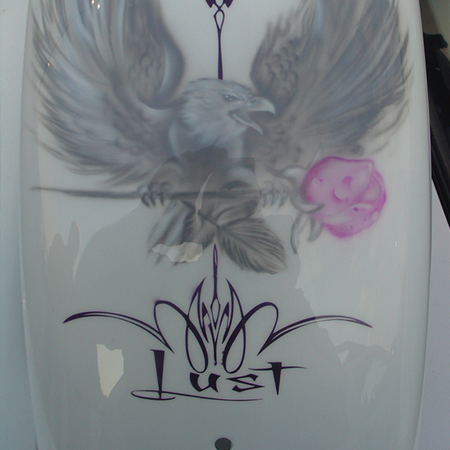 Custom motorcycle paint job with airbrushed eagles and pin striping