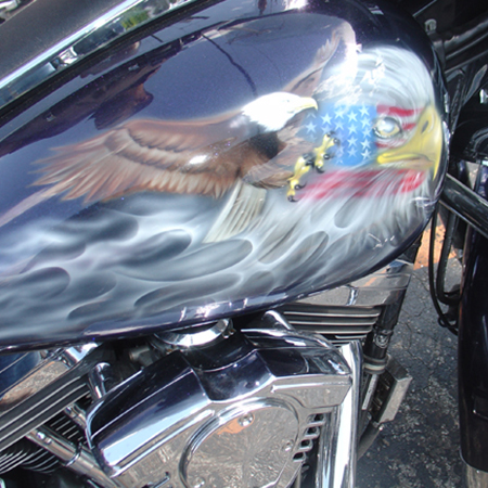 Custom motorcycle paint job with airbrushed eagles and flames
