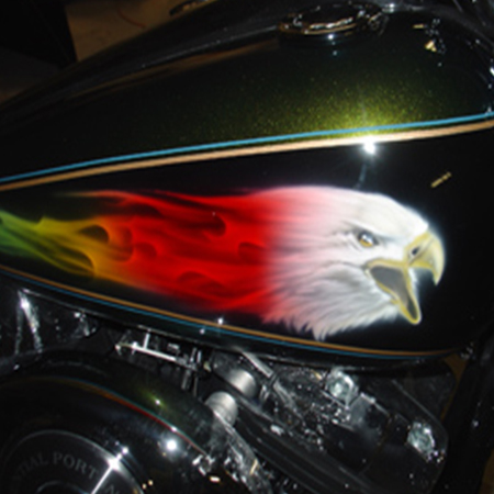 Custom motorcycle paint job with airbrushed eagles and kandy paint