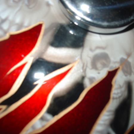 custom painted motorcycle gas tank with airbrushed skulls