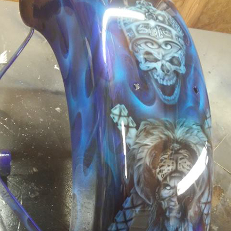 custom painted motorcycle paint job with airbrushed skulls and aztec imagery