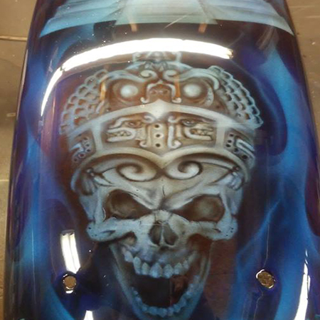 custom painted motorcycle paint job with airbrushed skulls and aztec imagery