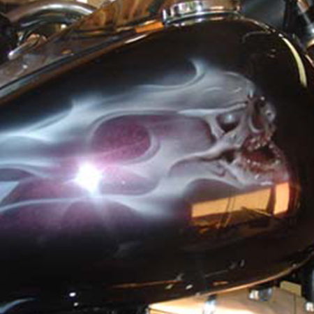 custom painted motorcycle with ghost flames and skulls