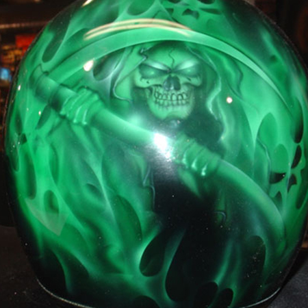 grim reaper and green flames on motorcycle helmet