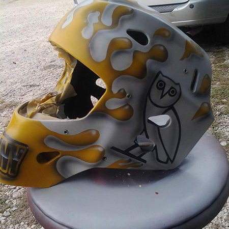 Drips and owl painted on goalie mask